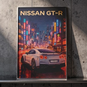 May include: A framed print featuring a white Nissan GT-R sports car driving through a neon-lit cityscape at night. The words "NISSAN GT-R" are at the top. The background shows Japanese text and colorful lights.