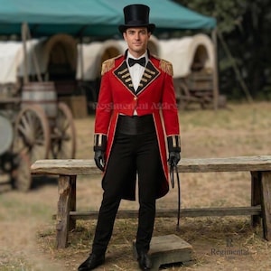 May include: A red tailcoat with gold fringe epaulets, black cuffs, and gold trim, worn with a black top hat, white shirt, black bow tie, black cummerbund, and black trousers. The ensemble includes black gloves and a black whip held in one hand.