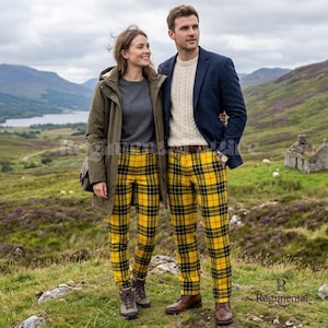 May include: Two individuals wearing matching yellow, black, and red plaid trousers. One wears an olive green hooded parka over a gray sweater, while the other wears a navy blue blazer over a cream cable-knit sweater and brown leather shoes.