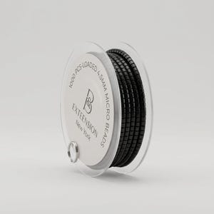 May include: A spool of black micro beads for hair extensions. The clear plastic spool has the text "1000 PCS-LOADED 4.5MM MICRO BEADS" and "EXTEENSION New York" printed on it. The beads are tightly wound and appear to be made of a shiny material.