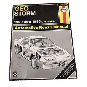 May include: A Haynes Automotive Repair Manual for the Geo Storm, covering models from 1990 to 1993. The cover features a detailed illustration of a Geo Storm with the text "Every manual based on a complete teardown and rebuild".
