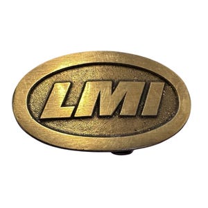 May include: A gold-colored oval belt buckle with the letters "LMI" embossed in the center.