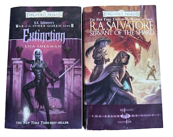 May include: Two paperback books from the Forgotten Realms series. The book on the left is "Extinction" by Lisa Smedman, and the book on the right is "Servant of the Shard" by R.A. Salvatore. Both books are New York Times bestsellers.