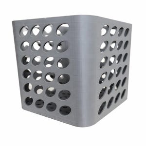 May include: A grey, cube-shaped storage basket featuring numerous evenly spaced circular holes. The basket has rounded corners and a smooth, matte finish. The design allows for ventilation and visibility of the contents.