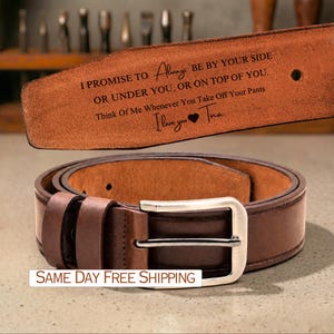 May include: A brown leather belt with a silver buckle. The belt has a message engraved on the inside that reads "I PROMISE TO Always BE BY YOUR SIDE OR UNDER YOU, OR ON TOP OF YOU. Think Of Me Whenever You Take Off Your Pants I love you Tina."