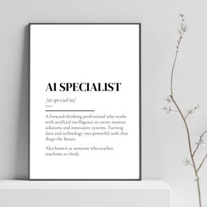 May include: A framed print with the text "AI SPECIALIST" in a bold, sans-serif font. Below, the phonetic pronunciation and a definition of the term are provided. The definition describes a professional working with AI to create innovative solutions.