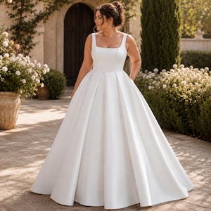 Plus Size Satin Wedding Dress, Square Neck Ballgown, Minimalist Bridal Gown, Elegant Reception Ceremony
Plus Curvy Bridal Gown, Lace Bohemian, Rustic Elegant Long sleeve, Slit A-line Wedding Dress
Plus Size Sparkly Boho Wedding Dress, Lace Bridal Gown with Open Back | Romantic Beach & Outdoor Wedding Dress