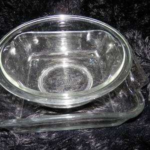 Square Baking Dish: Anchor Hocking Ovenware 8" x 8" x 2.25" (2 Qt) clear glass baking dish with molded handles.