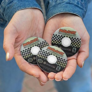 May include: Three Mario Kart Double Dash!! GameCube discs. Each disc features the game's logo in red and white, a checkered pattern, and the Nintendo GameCube logo. The discs are held in open hands.