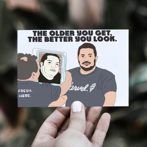 May include: A white card with the text "THE OLDER YOU GET, THE BETTER YOU LOOK."  A cartoon illustration of a man holding a mirror showing a younger version of himself. The text "FRESH. HERE." and "arvel." are also on the card.