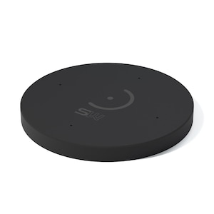 May include: A black, circular device with a flat top and rounded edges. The top surface features a curved line design and the letters "SW". There are four small holes evenly spaced around the edge.