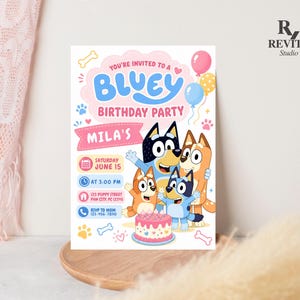 May include: A rectangular birthday party invitation featuring Bluey characters, a pink cake, and balloons. Text includes: YOU'RE INVITED TO A BLUEY BIRTHDAY PARTY, MILA'S, SATURDAY JUNE 15, AT 3:00 PM, 123 PUPPY STREET PAW CITY, PC 12345, and RSVP TO MOM 123-456-7890.