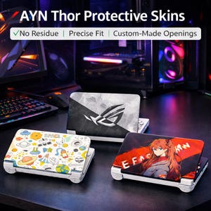May include: Protective skins for the AYN Thor handheld gaming device. The image shows three devices with different designs: a black and white design with a logo, a colorful space-themed design, and a design with anime art. The text on the image says "No Residue", "Precise Fit", and "Custom-Made Openings".