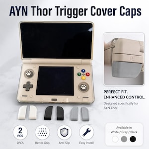 May include: AYN Thor trigger cover caps in white, gray, and black. The image shows a gaming console with the cover caps and text that says "Perfect Fit. Enhanced Control. Designed specifically for AYN Thor."