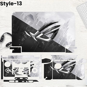 May include: A black and white laptop skin set with a futuristic city design and the text "Style-13". The set includes skins for the laptop lid, keyboard area, and other components, featuring the ROG logo.