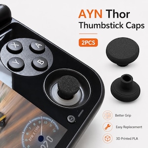 May include: Black thumbstick caps for a gaming device, with the text "AYN Thor Thumbstick Caps" and "2PCS". The image also shows a gaming device with buttons and a screen displaying a car's dashboard. Features include better grip and easy replacement.
