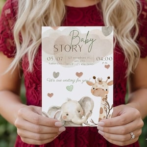 May include: A baby shower invitation with the words "Baby Story" in elegant script. The invitation features illustrations of an elephant and a giraffe, along with the date, time, and RSVP information. The invitation is held by a person.