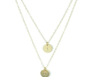 Layered initial charm necklace.