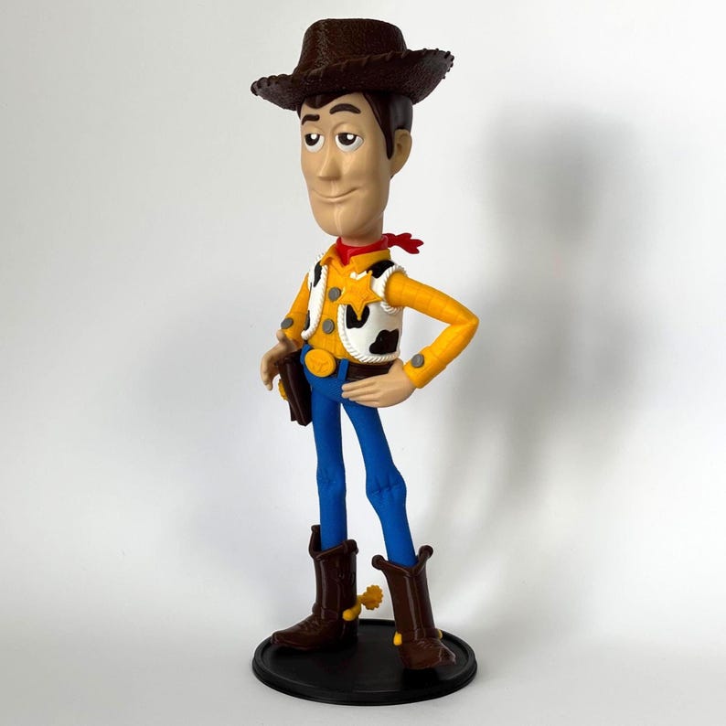 May include: A standing cowboy figurine wearing a brown hat, a yellow long-sleeved shirt, a white cow-print vest with a yellow sheriff star, blue pants, and brown boots with yellow spurs. The character has a tan complexion and brown hair.