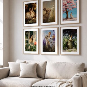 Könnte beinhalten: Ein Set aus sechs gerahmten Wandbildern mit verschiedenen Hasenillustrationen. Die Bilder zeigen Hasen in Umgebungen mit Sonnenblumen, weißen Blumen, einem Kirschblütenbaum, einem Gartenzaun, Lavendelfeldern und einer Gießkanne.