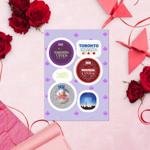 May include: A sticker sheet featuring five distinct Canadian-themed designs with the year 2026. The stickers include circular and rectangular shapes displaying city names like Toronto, Montreal, and Vancouver, along with maple leaf motifs and skyline imagery.