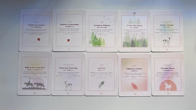 May include: Ten rectangular cards arranged in two rows, each featuring a unique title, descriptive text in English and Japanese, and a small illustration. The cards depict themes like nature, animals, and abstract concepts with soft, muted colour gradients.