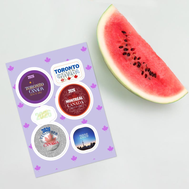 May include: A light purple sticker sheet featuring a repeating pattern of small pink maple leaves and six distinct circular and rectangular stickers with Canadian city themes, including Toronto, Montreal, and Vancouver, alongside a slice of watermelon.