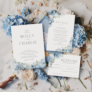 Op de afbeelding: Trouwuitnodigingsset met een bloemmotief. De uitnodiging toont de namen "Molly en Charlie", evenementdetails en een antwoordkaart. Blauwe hortensia's, een lakzegel en bloemen zijn ook aanwezig.