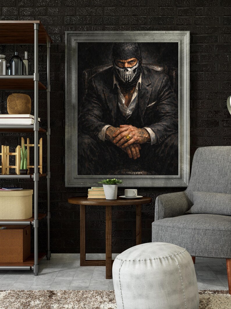 May include: A framed portrait of a person wearing a black balaclava with a skull design, a suit, and a white shirt. The person is seated in a dark chair with hands clasped. The room has a dark brick wall, a side table, and a gray armchair.
