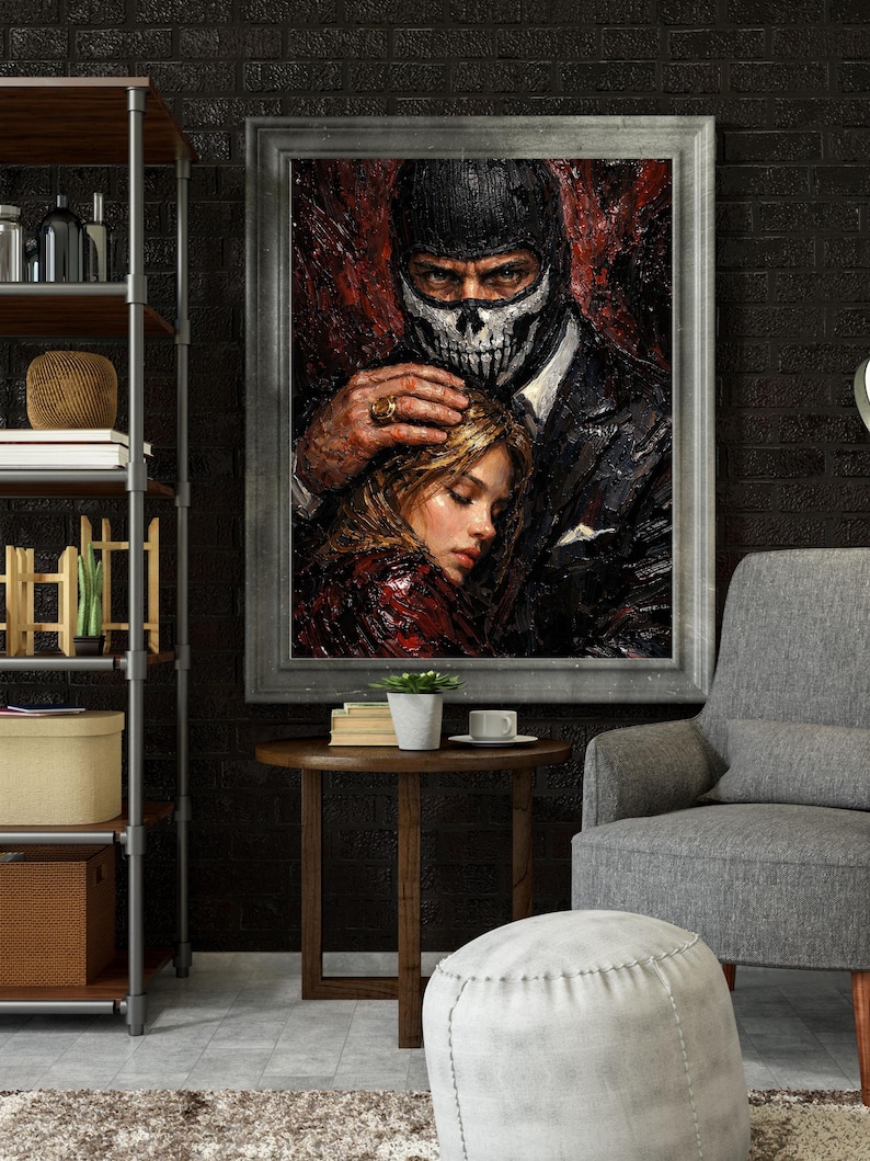 May include: A framed painting depicts a man in a black suit and skull mask holding a woman. The artwork has a dark, dramatic color palette with red and black tones. The man's hand rests on the woman's head, creating a sense of protection.