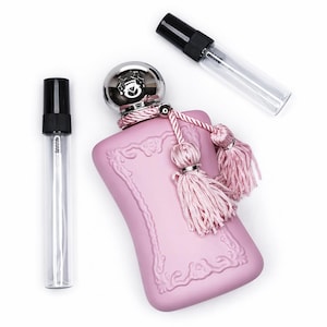 May include: A set of three ceramic mugs with a speckled, matte finish. The mugs are in shades of cream, light gray, and dark gray. Each mug has a simple, minimalist design and a rounded handle.