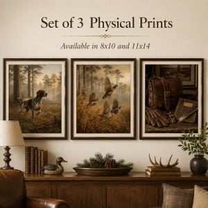 May include: A set of 3 physical prints with the text Set of 3 Physical Prints Available in 8x10 and 11x14. The prints feature a hunting dog in a forest, birds in tall grass, and a leather bag with gloves and a whistle on a wooden surface.