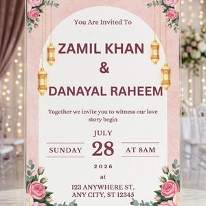 Puede incluir: Un letrero de invitaci&oacute;n de boda de acr&iacute;lico transparente con fondo de arco blanco, bordes florales rosas y linternas doradas colgantes. El texto dice: You Are Invited To ZAMIL KHAN & DANAYAL RAHEEM, Together we invite you to witness our love story begin, JULY SUNDAY 28 AT 8AM 2026 at 123 ANYWHERE ST, ANY CITY, ST 12345.