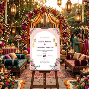 Puede incluir: Un letrero rectangular de invitaci&oacute;n de boda sobre un caballete de madera con fondo rosa, un centro blanco arqueado, detalles florales y el texto: You Are Invited To ZAMIL KHAN & DANAYAL RAHEEM, Sunday July 28 2026 at 8AM, 155 Anywhere St.