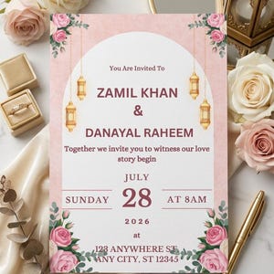 Puede incluir: Una tarjeta de invitaci&oacute;n de boda rectangular con fondo rosa, un arco blanco, linternas doradas colgantes e ilustraciones de rosas. El texto dice: You Are Invited To ZAMIL KHAN & DANAYAL RAHEEM, JULY 28, 2026, at 123 ANYWHERE ST, ANY CITY, ST 12345.