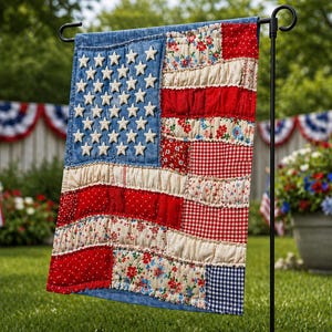 May include: A patriotic garden flag resembling the American flag, featuring a blue denim field with white stars and red and white stripes. The flag is made of patchwork fabric and is displayed outdoors on a black metal stand.