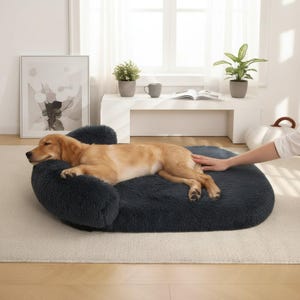 May include: A dark gray, plush, rectangular pet bed with raised, cushioned bolsters on three sides. The bed features a soft, shaggy, faux-fur texture and is designed to provide a comfortable, supportive surface for a pet to rest and sleep.