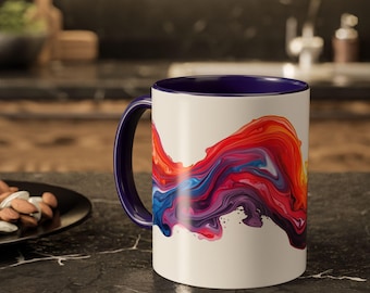 Taza de cerámica con diseño de remolino de pintura arcoíris y salpicaduras de color.