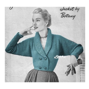 May include: A teal blue knitted cardigan with a double breasted closure and a wide collar. The cardigan is styled with a grey skirt and the text "Jacket by Botany" is visible in the top right corner of the image.