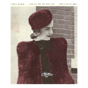 May include: A woman wearing a burgundy knitted hat and a matching burgundy knitted jacket. The jacket has a fluffy texture and the hat is a beret style.