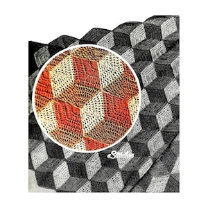 May include: A close-up of a crocheted blanket with a 3D cube pattern. The blanket is made in shades of brown, gray, and white. The center of the image shows a close-up of the cube pattern in shades of brown, orange, and white.
