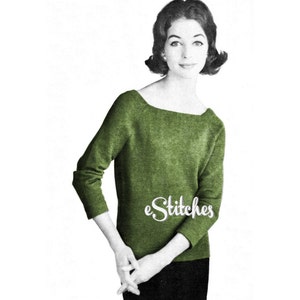 May include: A green sweater with a scoop neck and three-quarter sleeves. The sweater is knit and has a slightly textured surface. The model is wearing the sweater with black pants. The text "eStitches" is visible on the sweater.