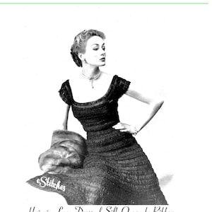May include: A black and white photo of a woman wearing a dress made of hairpin lace. The dress is made of silk organdy ribbon and has a square neckline. The dress is fitted through the bodice and flares out at the skirt. The woman is wearing a necklace and has her hair styled in a bun. The photo is captioned "Hairpin Lace Dress of Silk Organy Ribbon".
