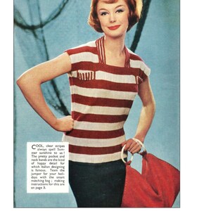 May include: A red and white striped knit top with a scoop neck and short sleeves. The top has a small pocket on the front and a contrasting white trim around the neck and sleeves. The model is wearing the top with a red handbag.