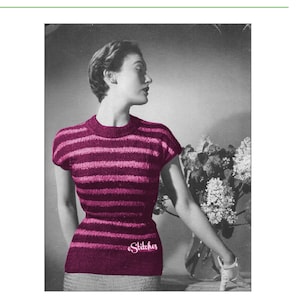 May include: A striped pink and white knit sweater with short sleeves. The sweater has a fitted silhouette and is photographed on a model standing next to a bouquet of flowers. The text "Stitches" is embroidered on the front of the sweater.