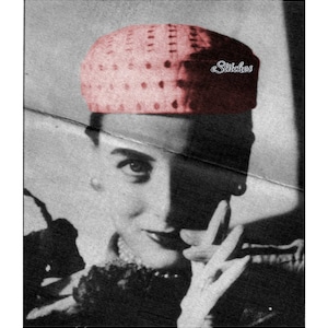 May include: A black and white photo of a woman wearing a pink and red polka dot hat with the word "Stitches" written on it. The woman is looking at the camera and has her hand covering part of her face.