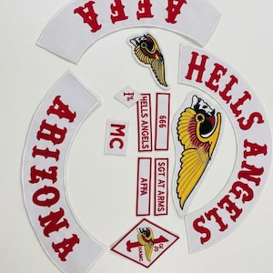 May include: A collection of white and red embroidered patches. The patches include the words "Arizona", "Hells Angels", "AFFA", "SGT AT ARMS", and "MC". Several patches feature a winged skull graphic.