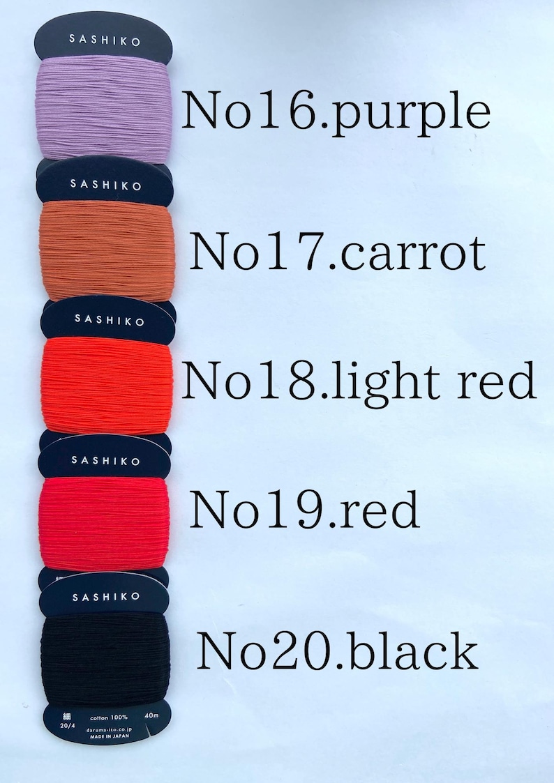 May include: Five spools of Sashiko thread stacked vertically, labeled No16 purple, No17 carrot, No18 light red, No19 red, and No20 black. Each spool features a black card with white text, 100% cotton, 40m length, and 20/4 thread weight.
