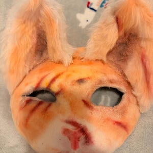 Scarred orange tabby cat mask, perfect for quads and *drumroll pls, one of humanities greatest fears,* SELF EXPRESSION. Have fun!