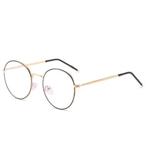May include: Round eyeglasses with a gold metal frame and black accents. The clear lenses are set in a classic, minimalist design. These glasses are suitable for everyday wear and offer a stylish look.